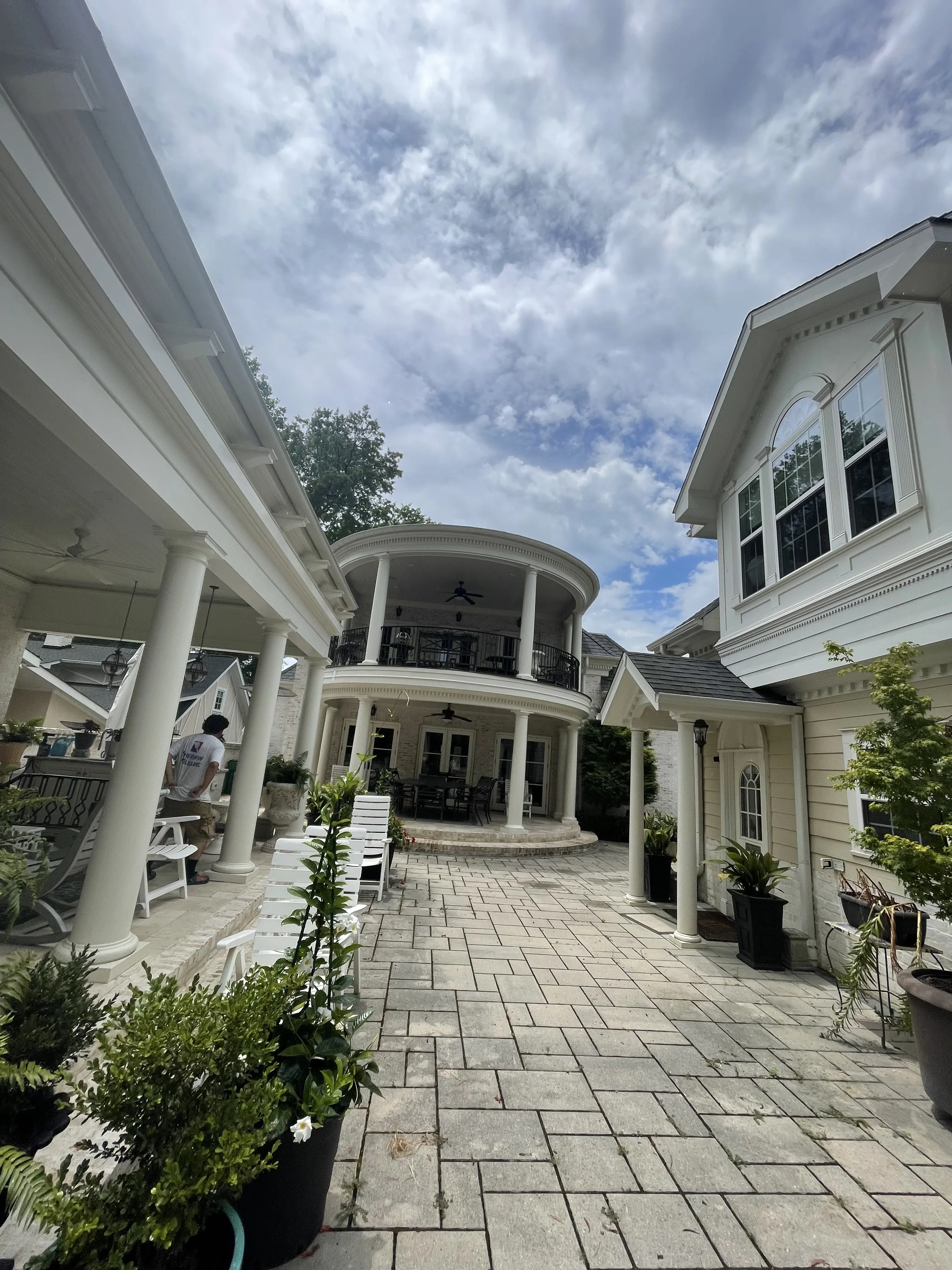 Charlotte residence with freshly painted white columns, a curved portico, and classical trim